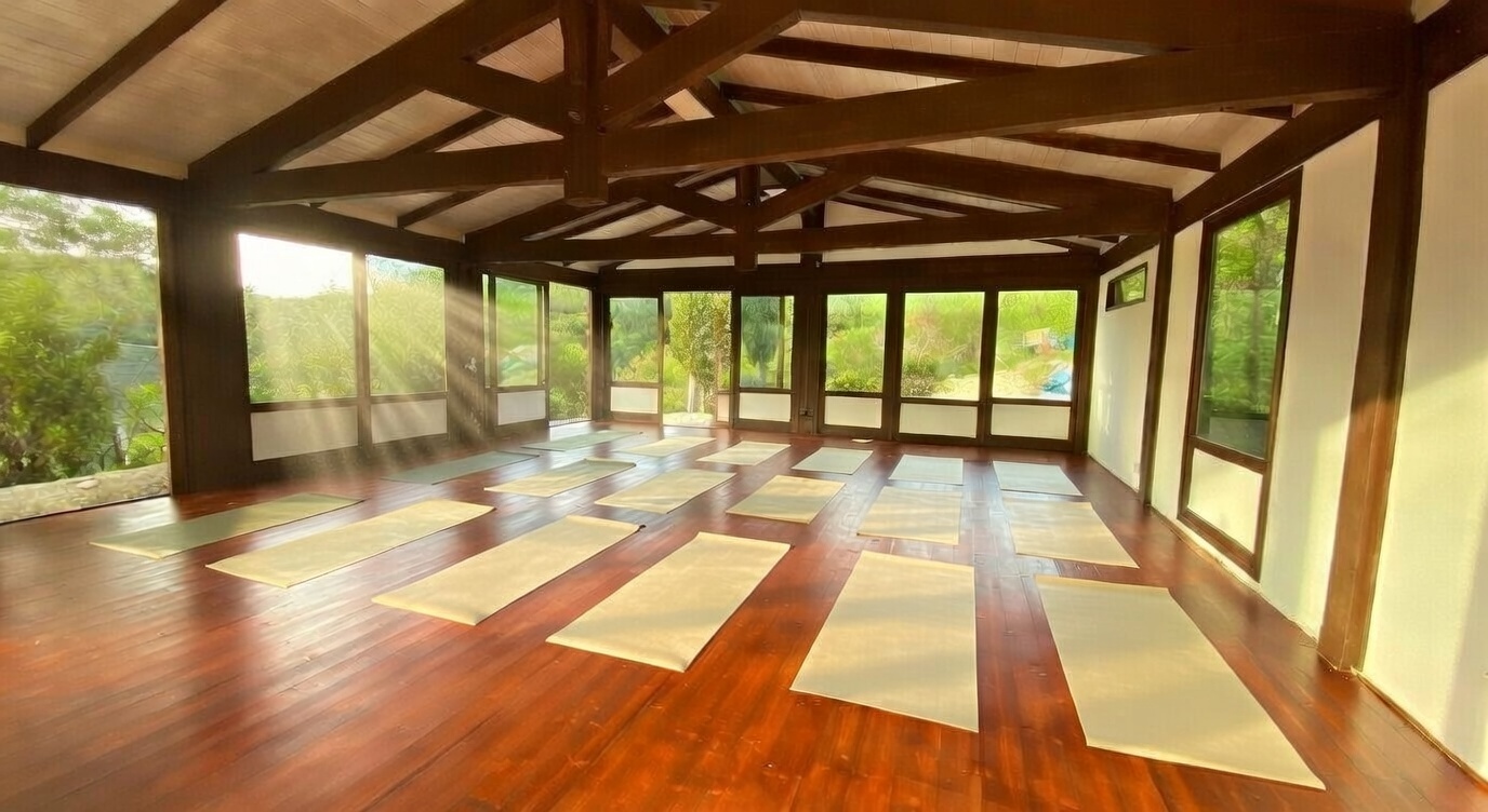 Spacious indoor yoga shala with large windows overlooking the Italian hills